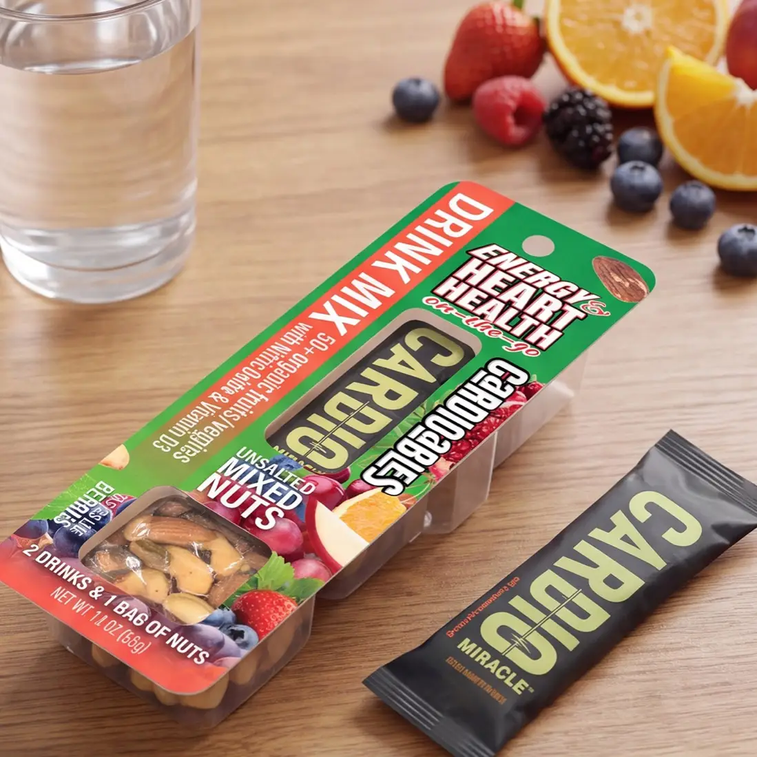 A Cardioables pack on a table with a glass of water, fruit and a drink stick